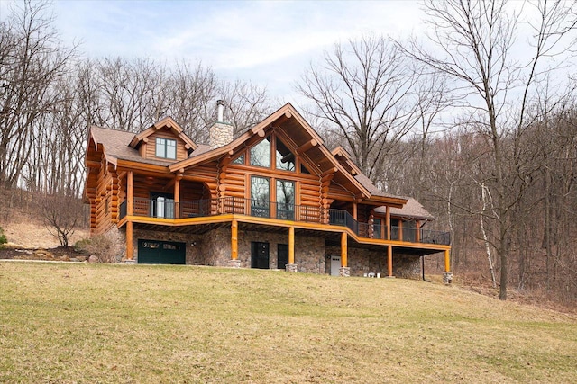 N8070 Wanlass Rd, Mindoro, WI 54644 - rear view of property with a lawn, log siding, stone siding, a chimney, and a garage