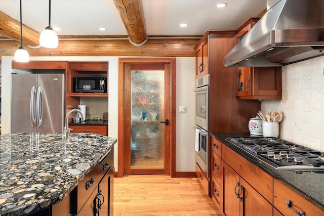 N8070 Wanlass Rd, Mindoro, WI 54644 - kitchen featuring a sink, light wood-style floors, brown cabinetry, stainless steel appliances, and extractor fan