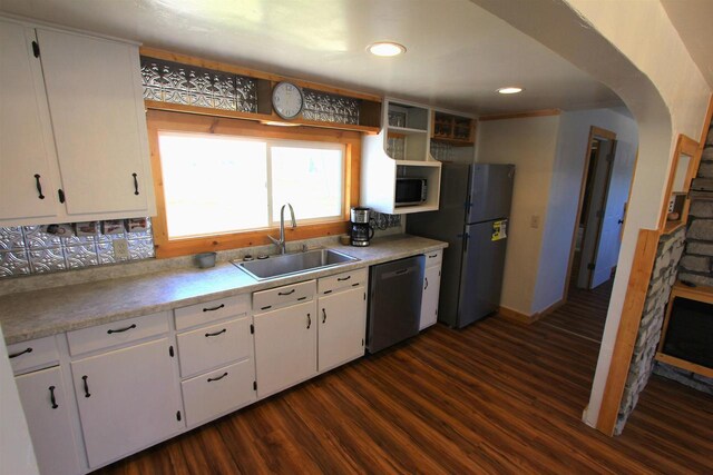 W7675 Moonshine Hill Rd, Wausaukee, WI 54177 - kitchen with arched walkways, a sink, dark wood-style flooring, appliances with stainless steel finishes, and white cabinetry