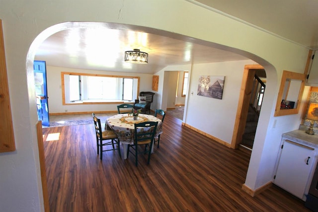 W7675 Moonshine Hill Rd, Wausaukee, WI 54177 - dining room featuring arched walkways, baseboards, dark wood-style floors, and stairway