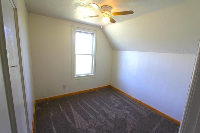 W7675 Moonshine Hill Rd, Wausaukee, WI 54177 - additional living space featuring dark colored carpet, baseboards, a ceiling fan, and lofted ceiling