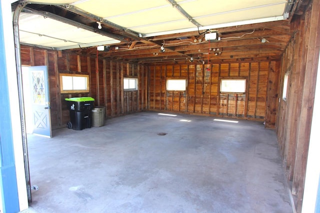 W7675 Moonshine Hill Rd, Wausaukee, WI 54177 - garage featuring a garage door opener and wooden walls
