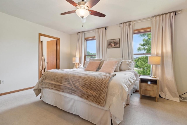 178 Weybridge Dr, Sun Prairie, WI 53590 - bedroom featuring multiple windows, light colored carpet, baseboards, and ceiling fan