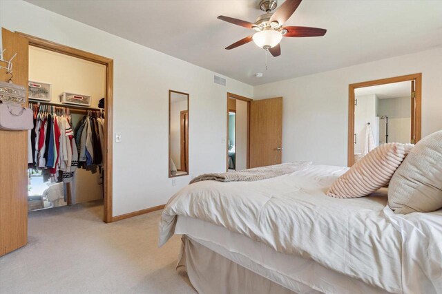178 Weybridge Dr, Sun Prairie, WI 53590 - bedroom featuring light colored carpet, a walk in closet, a closet, baseboards, and a ceiling fan