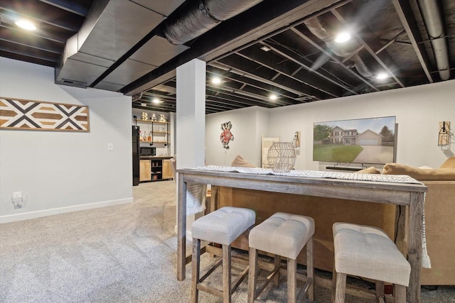 178 Weybridge Dr, Sun Prairie, WI 53590 - indoor dry bar featuring carpet floors, black appliances, and baseboards