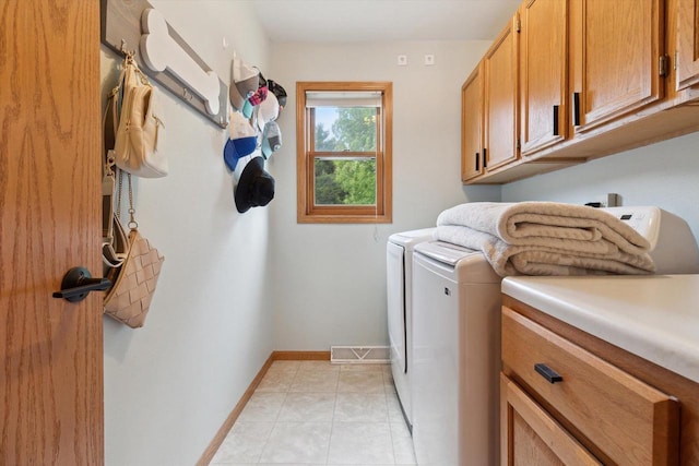 178 Weybridge Dr, Sun Prairie, WI 53590 - laundry room featuring cabinet space, separate washer and dryer, baseboards, and light tile patterned floors