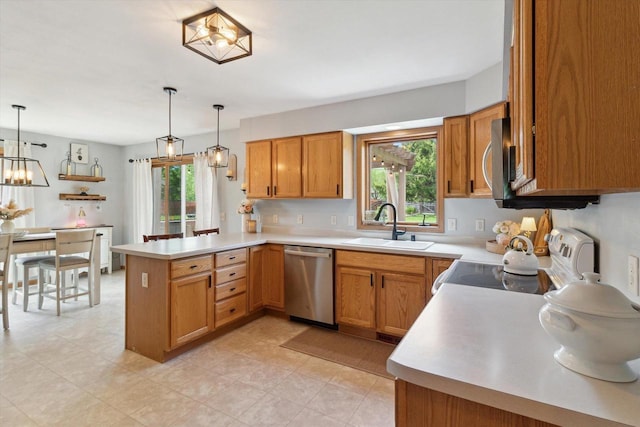 178 Weybridge Dr, Sun Prairie, WI 53590 - kitchen featuring appliances with stainless steel finishes, a peninsula, a sink, light countertops, and decorative light fixtures