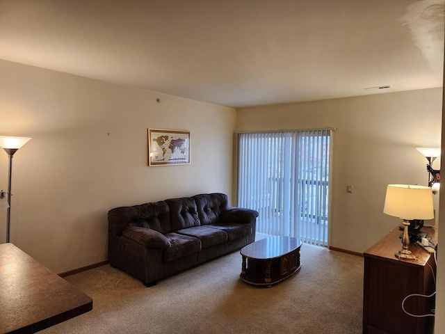 living area featuring carpet flooring and baseboards