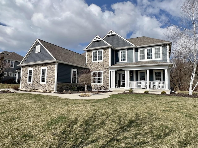 W246N1979 Still River Dr, Pewaukee, WI 53072 - craftsman house featuring covered porch, a front yard, and stone siding