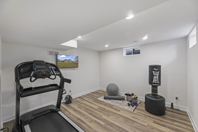 W246N1979 Still River Dr, Pewaukee, WI 53072 - workout area featuring visible vents, baseboards, and wood finished floors