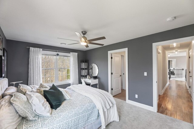 W246N1979 Still River Dr, Pewaukee, WI 53072 - bedroom with light carpet, baseboards, and a ceiling fan