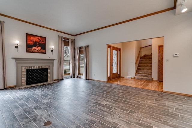 4510 Choctaw Trl, Green Bay, WI 54313 - unfurnished living room featuring crown molding, stairway, wood finished floors, a brick fireplace, and baseboards