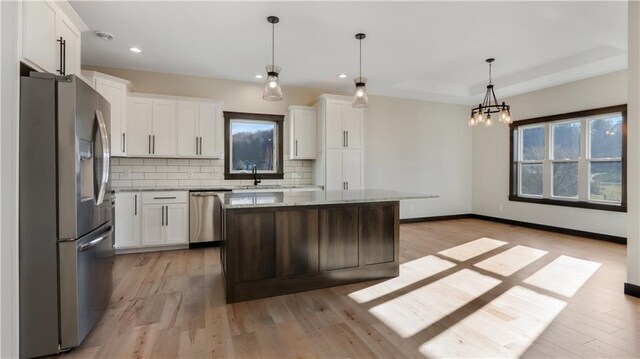 LOT3 510th Ave, Menomonie, WI 54751 - kitchen with decorative backsplash, light wood-style flooring, a sink, and appliances with stainless steel finishes
