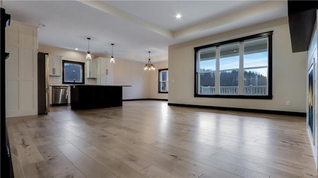 LOT3 510th Ave, Menomonie, WI 54751 - unfurnished living room with light wood-style flooring, a notable chandelier, baseboards, and recessed lighting