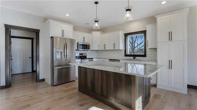 LOT3 510th Ave, Menomonie, WI 54751 - kitchen featuring decorative backsplash, white cabinetry, a sink, and appliances with stainless steel finishes