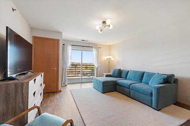 living area featuring light wood-style floors and visible vents