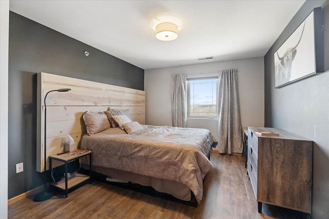 bedroom with wood finished floors and visible vents