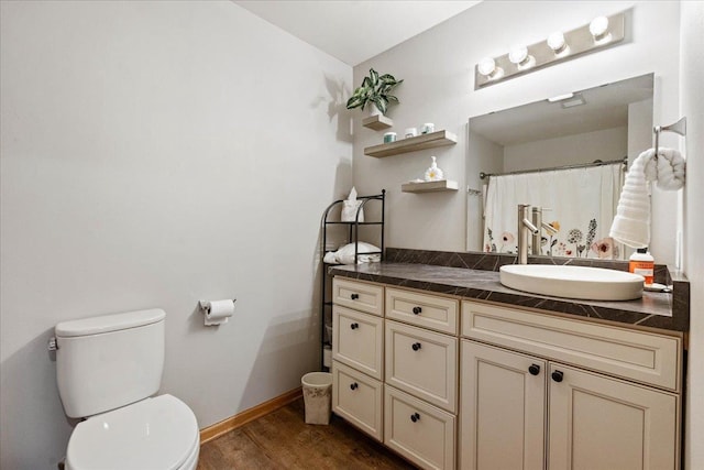 bathroom featuring wood finished floors, vanity, baseboards, toilet, and a shower with shower curtain