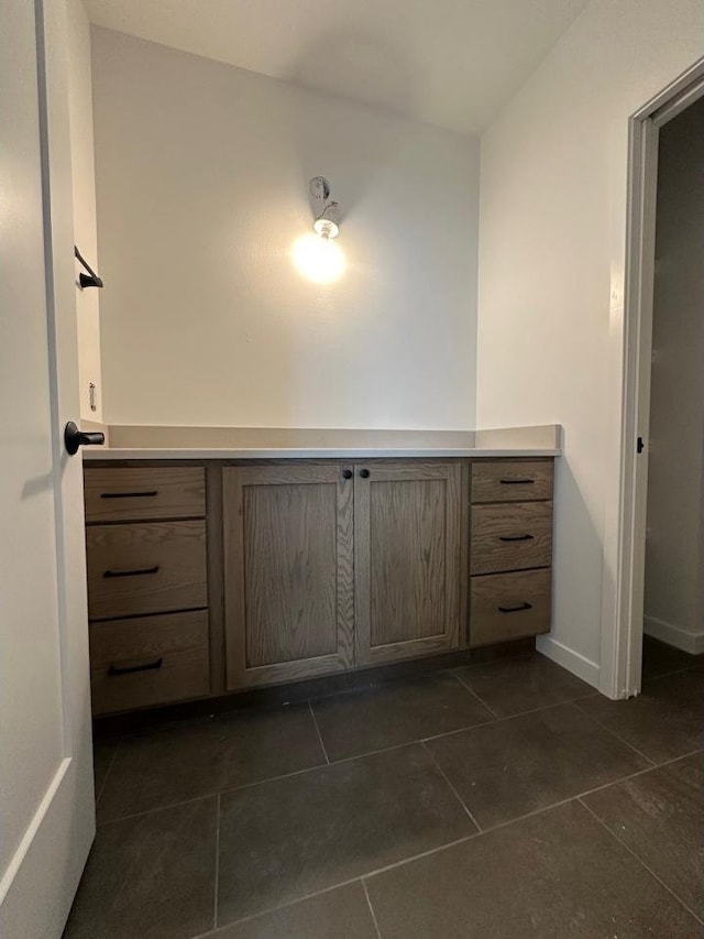 1310 Spahn Dr, Waunakee, WI 53597 - bathroom with tile patterned floors, vanity, and baseboards
