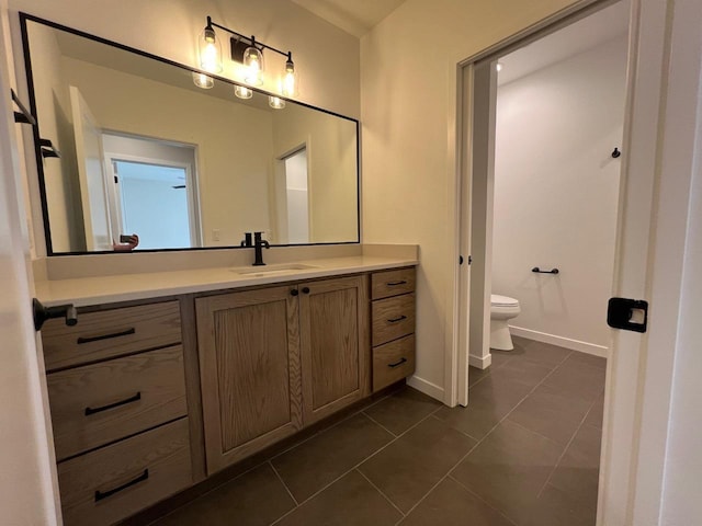 1310 Spahn Dr, Waunakee, WI 53597 - bathroom with tile patterned flooring, vanity, toilet, and baseboards