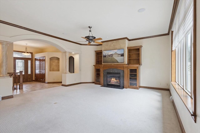 1716 Symphony Hts, Green Bay, WI 54311 - unfurnished living room with arched walkways, light colored carpet, ornamental molding, a ceiling fan, and baseboards