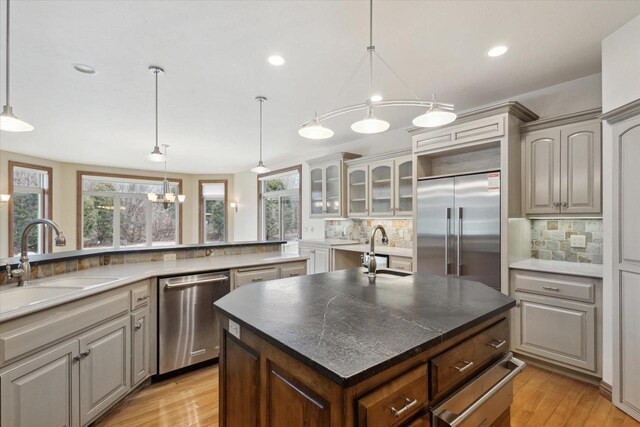 1716 Symphony Hts, Green Bay, WI 54311 - kitchen with a warming drawer, decorative backsplash, a sink, and stainless steel appliances