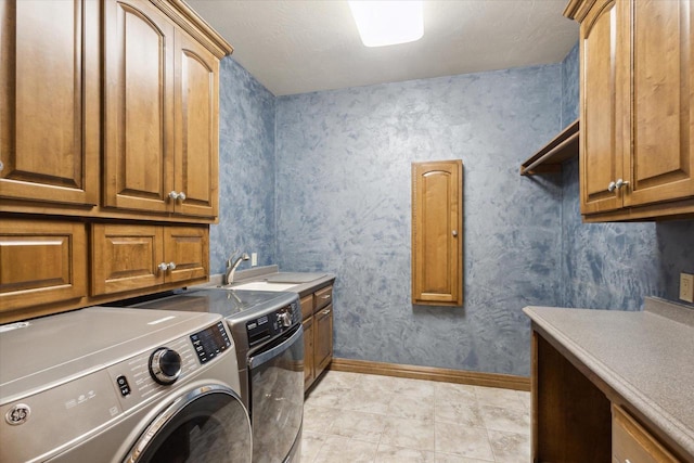 1716 Symphony Hts, Green Bay, WI 54311 - washroom featuring baseboards, washer and clothes dryer, a sink, and cabinet space