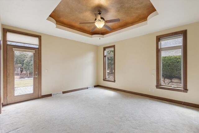 1716 Symphony Hts, Green Bay, WI 54311 - spare room with baseboards, a raised ceiling, carpet flooring, visible vents, and ceiling fan