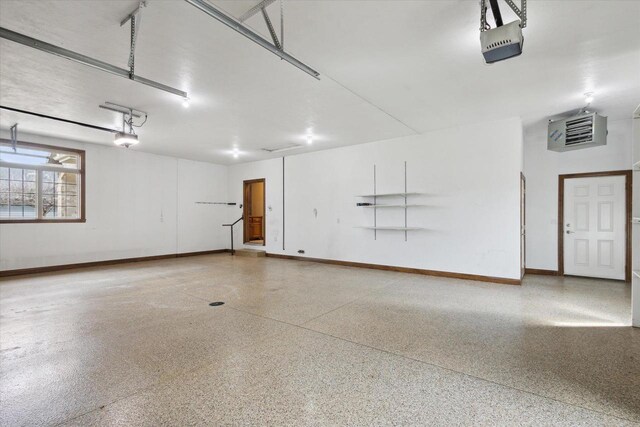 1716 Symphony Hts, Green Bay, WI 54311 - garage featuring a garage door opener and baseboards