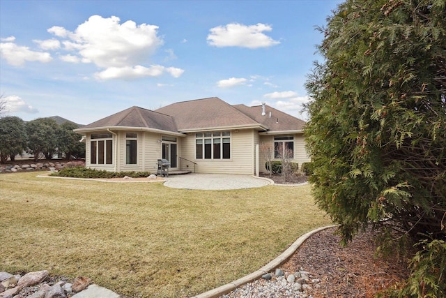 1716 Symphony Hts, Green Bay, WI 54311 - rear view of property featuring entry steps, a shingled roof, a patio, and a lawn