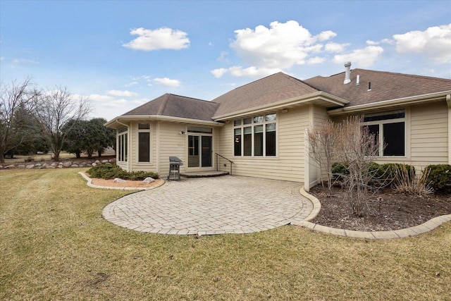 1716 Symphony Hts, Green Bay, WI 54311 - back of property with a yard, a patio area, and a shingled roof