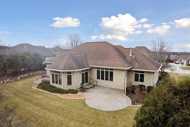 1716 Symphony Hts, Green Bay, WI 54311 - rear view of house with a patio area, roof with shingles, and a yard