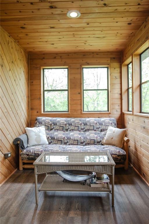 6009 W Dobbert Rd, Winter, WI 54896 - sitting room featuring wooden walls, wooden ceiling, and wood finished floors