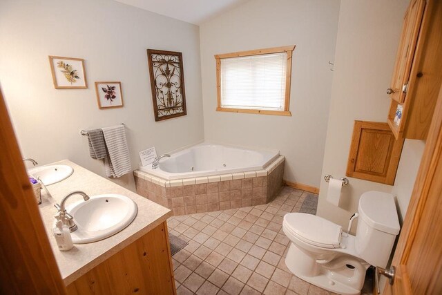 6009 W Dobbert Rd, Winter, WI 54896 - full bath with a whirlpool tub, double vanity, tile patterned floors, toilet, and a sink