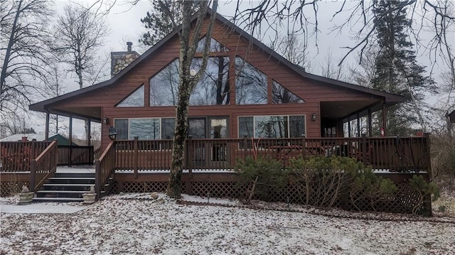 6009 W Dobbert Rd, Winter, WI 54896 - snow covered back of property with a deck and a chimney