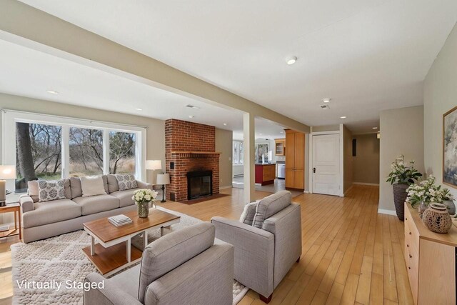 149 Oakwood Ave, Edgerton, WI 53534 - living area with light wood-style flooring, recessed lighting, a brick fireplace, and baseboards