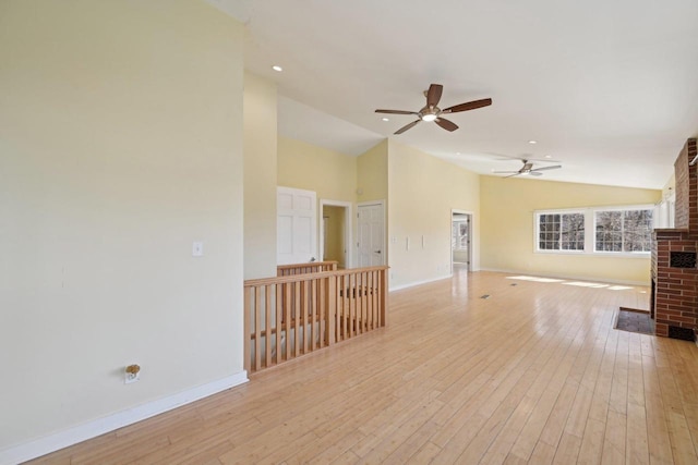 149 Oakwood Ave, Edgerton, WI 53534 - unfurnished living room featuring light wood-style flooring, baseboards, a ceiling fan, and a fireplace