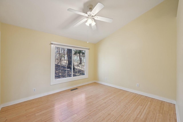 149 Oakwood Ave, Edgerton, WI 53534 - unfurnished room featuring visible vents, baseboards, light wood-type flooring, a ceiling fan, and vaulted ceiling