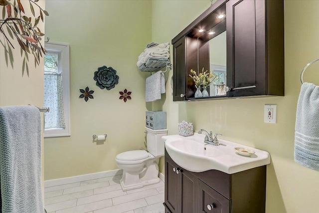 149 Oakwood Ave, Edgerton, WI 53534 - bathroom with toilet, baseboards, and vanity