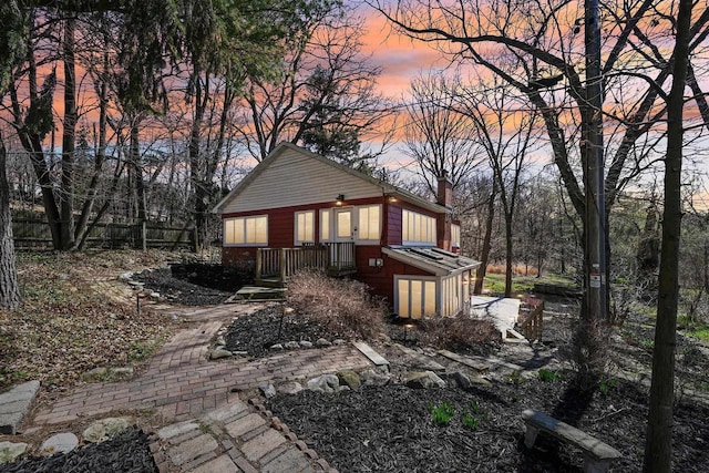 149 Oakwood Ave, Edgerton, WI 53534 - property exterior at dusk featuring a chimney