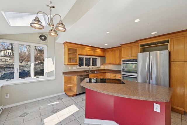 149 Oakwood Ave, Edgerton, WI 53534 - kitchen with stainless steel appliances, brown cabinets, baseboards, and a sink