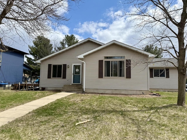 1411 Jennifer Ave, Tomah, WI 54660 - bungalow-style home with entry steps and a front lawn