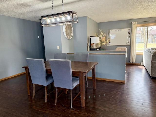 1411 Jennifer Ave, Tomah, WI 54660 - dining space featuring baseboards, wood finished floors, and a textured ceiling