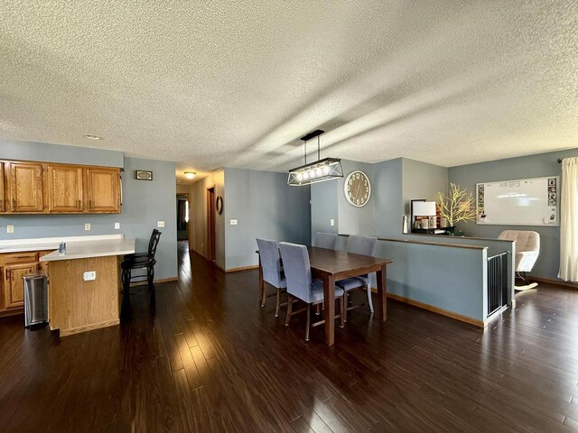 1411 Jennifer Ave, Tomah, WI 54660 - dining room with a textured ceiling, baseboards, and dark wood finished floors