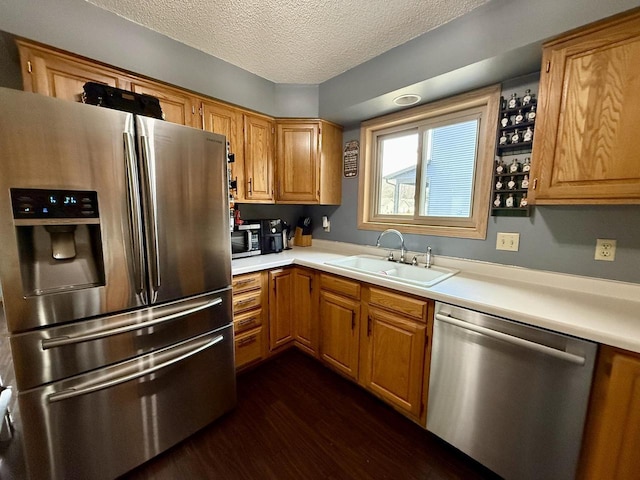1411 Jennifer Ave, Tomah, WI 54660 - kitchen with light countertops, a textured ceiling, a sink, and stainless steel appliances