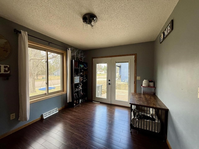1411 Jennifer Ave, Tomah, WI 54660 - doorway to outside with a textured ceiling, french doors, visible vents, and plenty of natural light