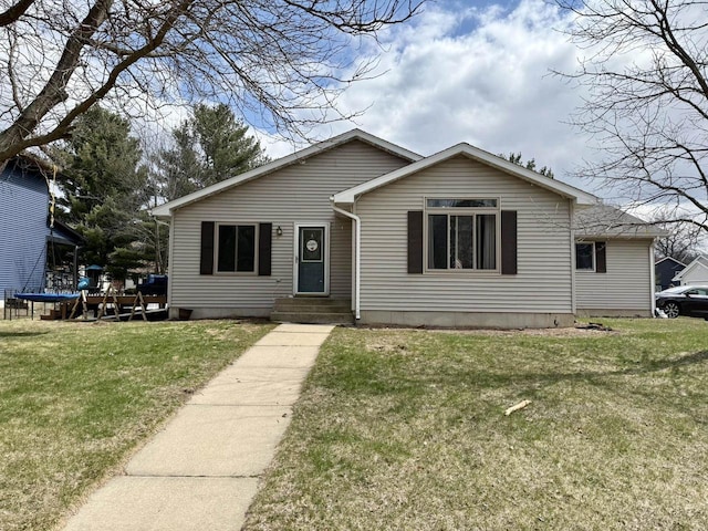 1411 Jennifer Ave, Tomah, WI 54660 - view of front of home with a front lawn and a trampoline
