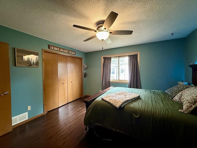 1411 Jennifer Ave, Tomah, WI 54660 - bedroom featuring a closet, a textured ceiling, visible vents, ceiling fan, and wood finished floors