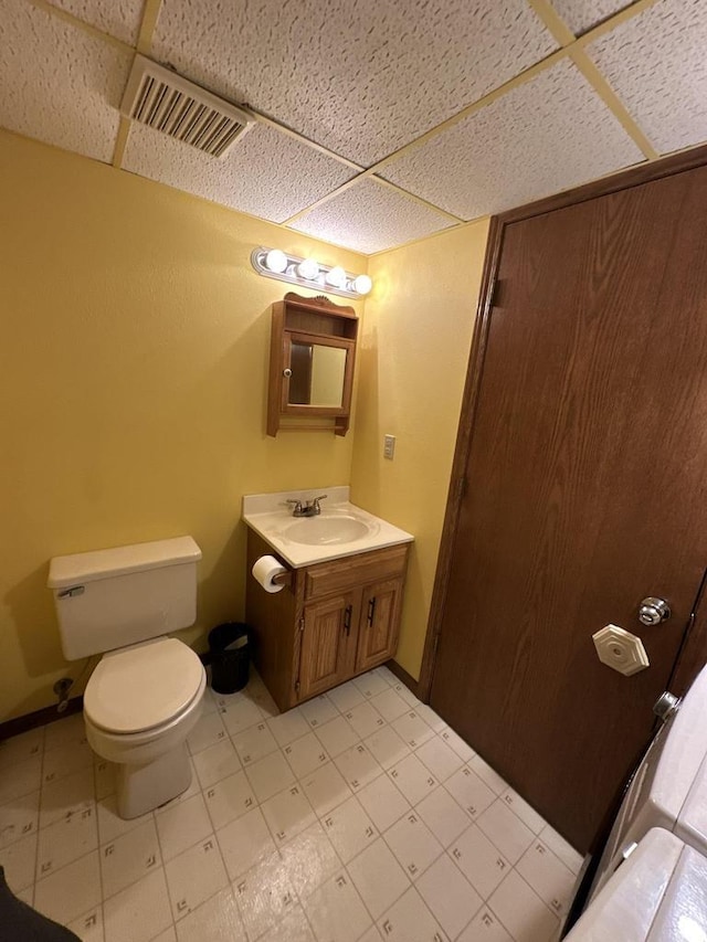 1411 Jennifer Ave, Tomah, WI 54660 - bathroom with tile patterned floors, visible vents, a drop ceiling, and toilet