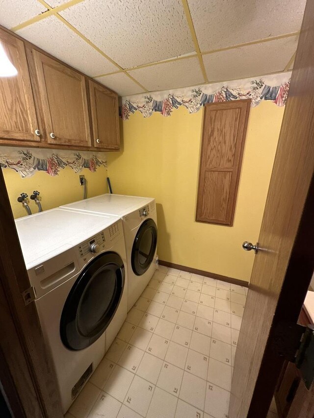 1411 Jennifer Ave, Tomah, WI 54660 - clothes washing area featuring separate washer and dryer, baseboards, light floors, and cabinet space